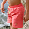 Boys swim shorts in peach colour with light green elastic waistband
