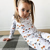 Little Girl Wearing Cute Halloween Pyjama set for Kids with Pumpkins and Ghosts Print
